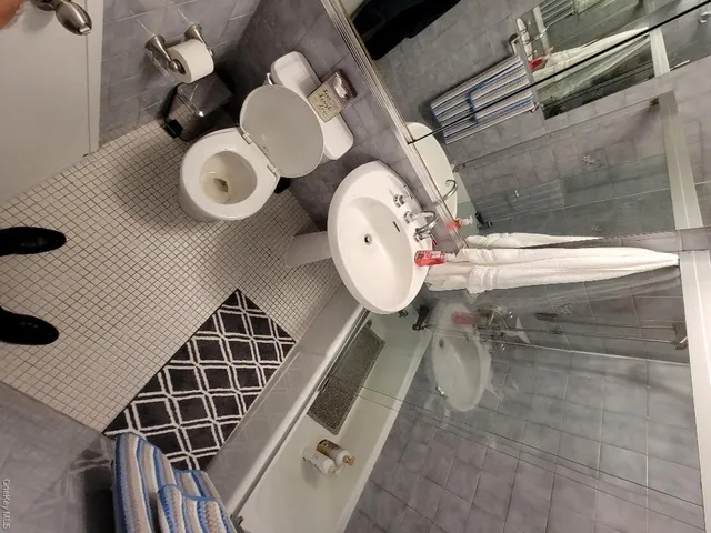 a white kitchen with sink and stove