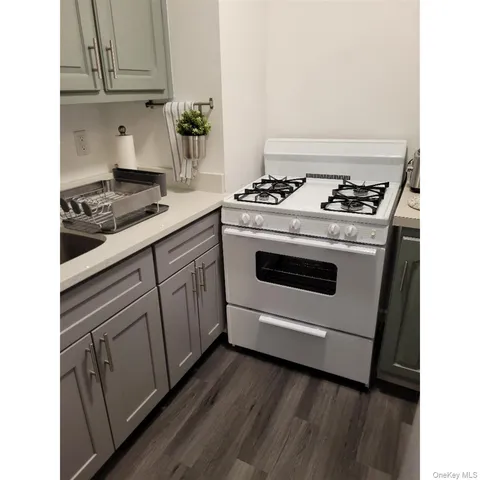 a white stove top oven sitting inside of a kitchen