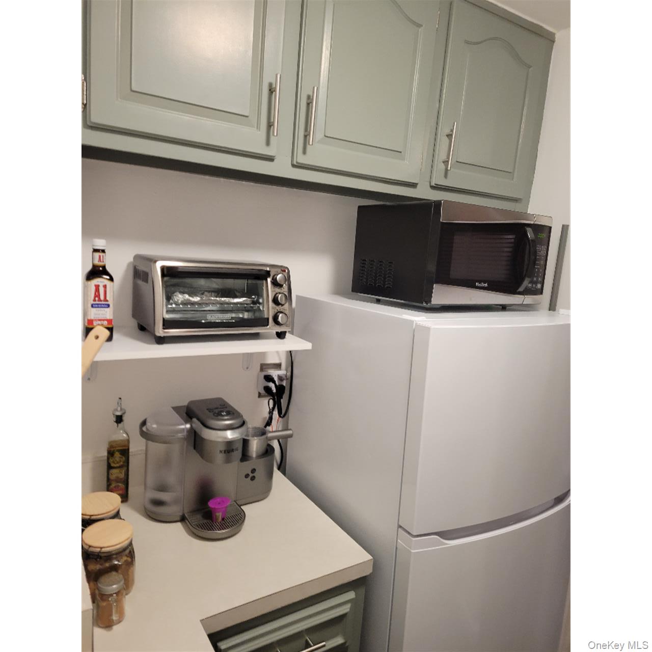 118-18 Union Turnpike, Unit 5J Queens, NY 11415 - Photo 19 of 24 a kitchen with a refrigerator and a stove