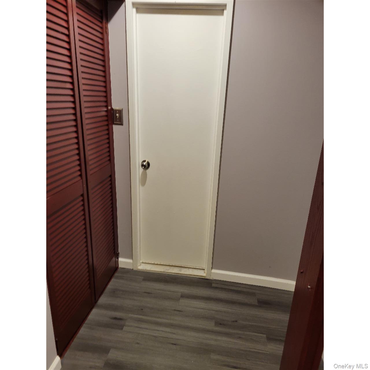 118-18 Union Turnpike, Unit 5J Queens, NY 11415 - Photo 23 of 24 a view of a hallway with wooden floor