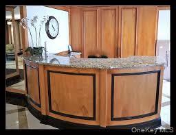 118-18 Union Turnpike, Unit 5J Queens, NY 11415 - Photo 3 of 24 a bathroom with a granite countertop sink and a mirror
