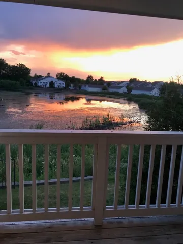 a view of a balcony with wooden floor and outdoor space