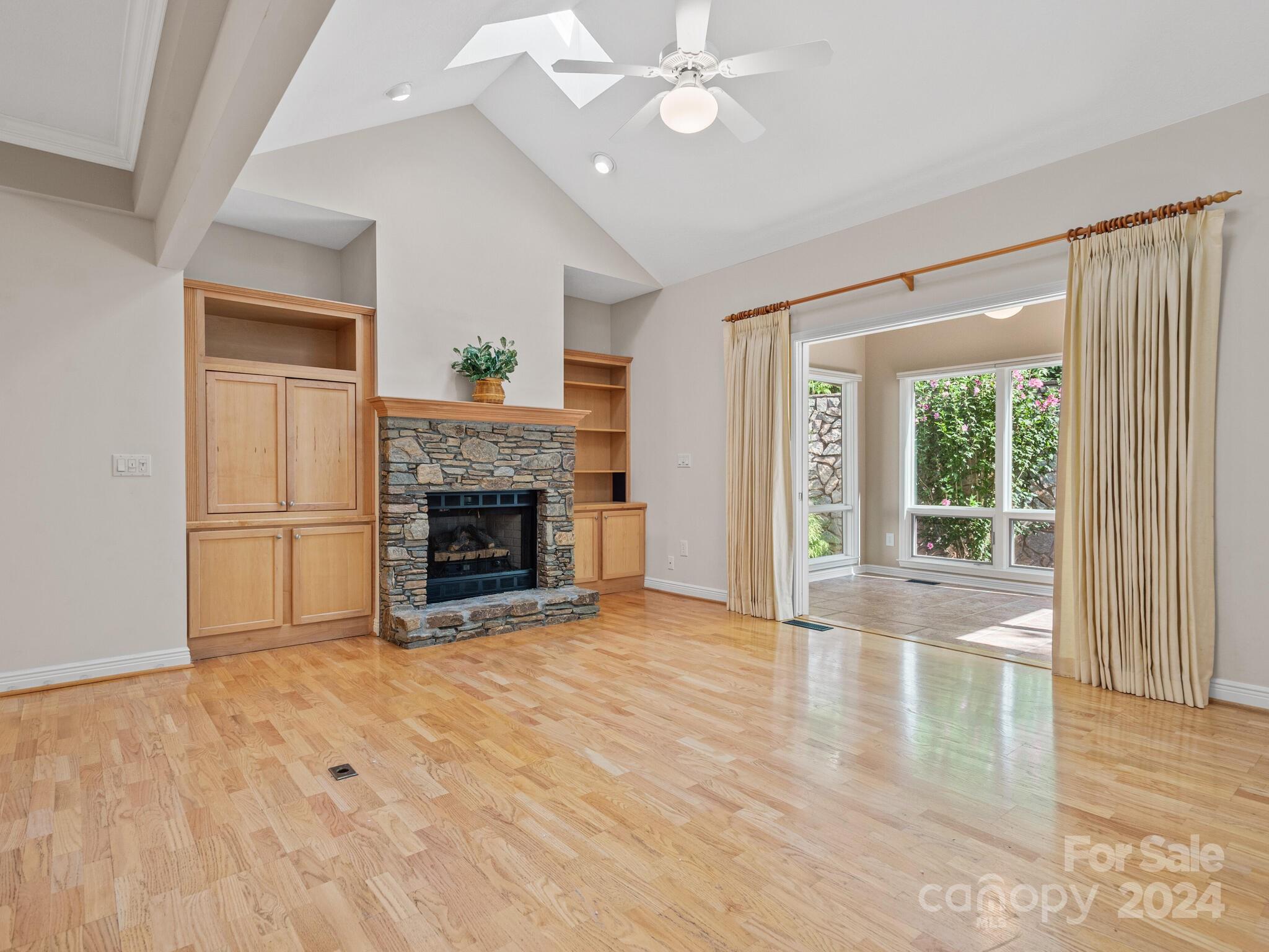 56 Pinnacle Point Drive Asheville, NC 28805 - Photo 13 of 38 a view of an empty room with wooden floor fireplace and a window