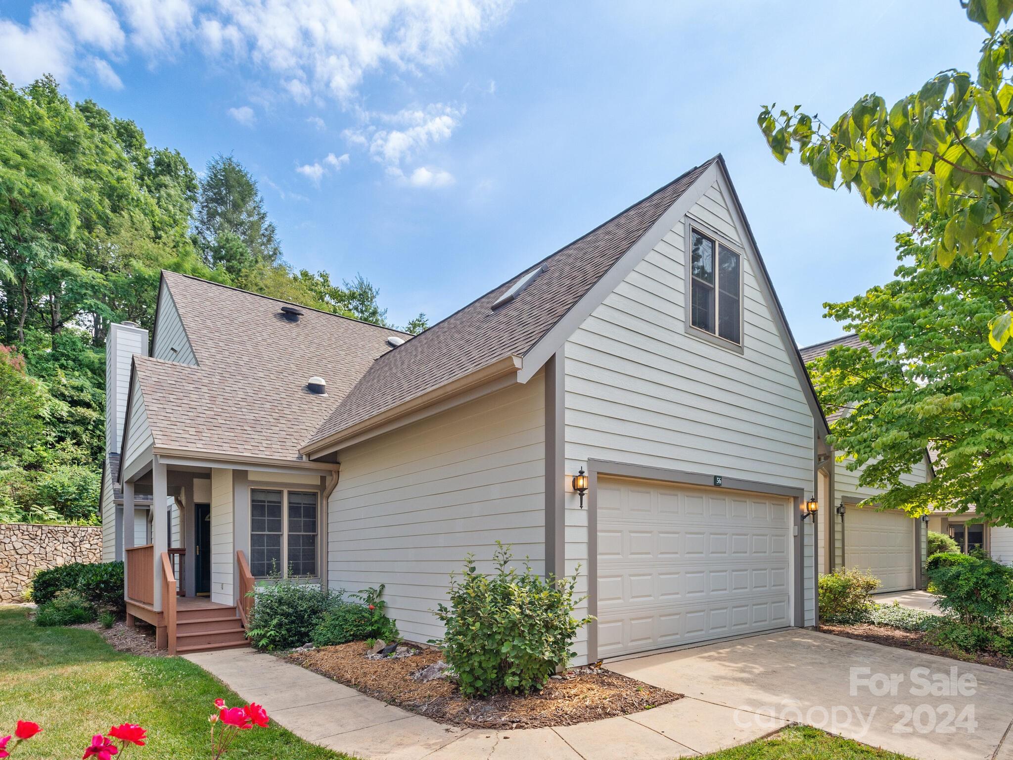 56 Pinnacle Point Drive Asheville, NC 28805 - Photo 2 of 38 a view of a house with brick walls plants and large tree