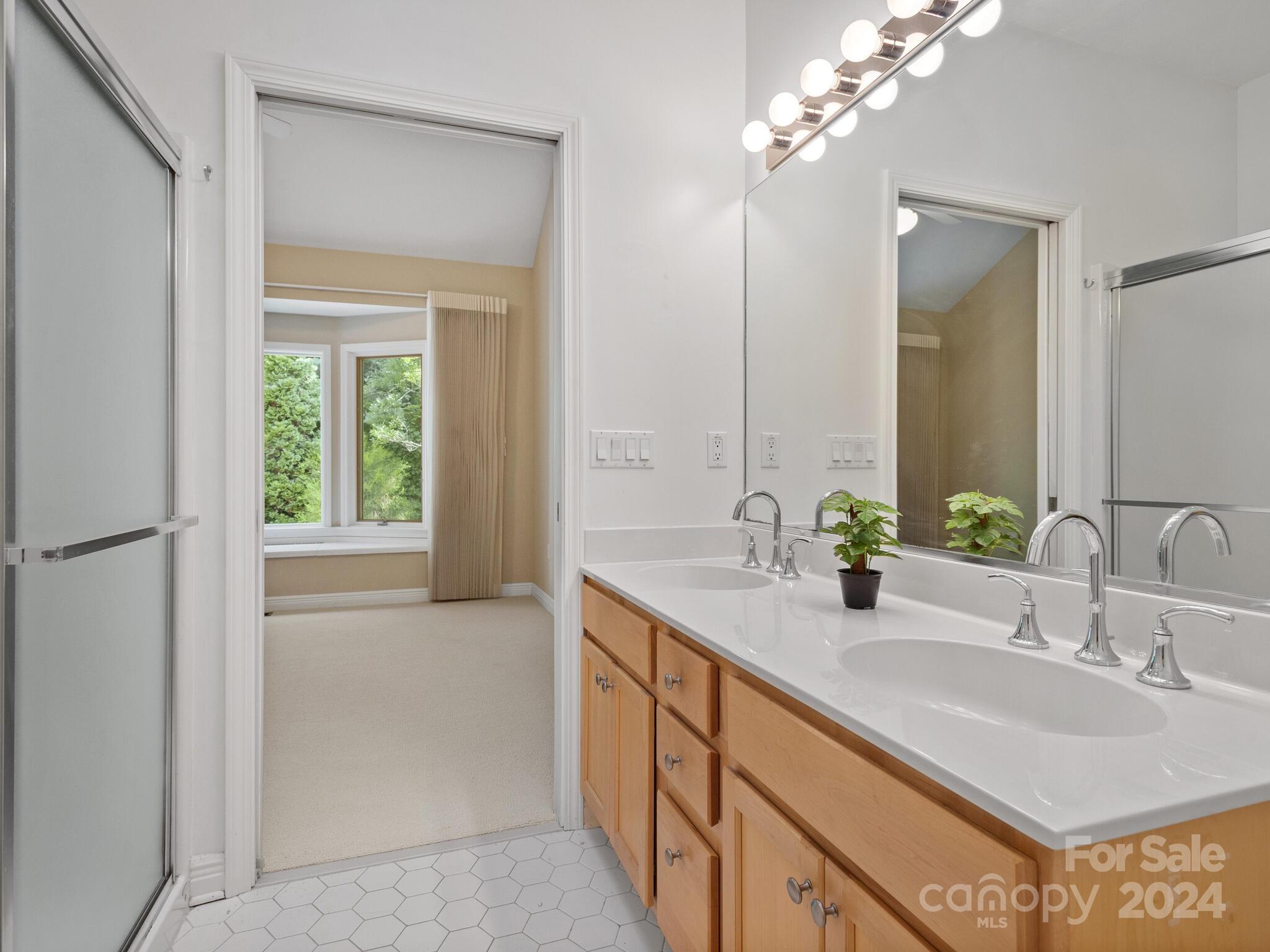 56 Pinnacle Point Drive Asheville, NC 28805 - Photo 24 of 38 a bathroom with a sink and a mirror