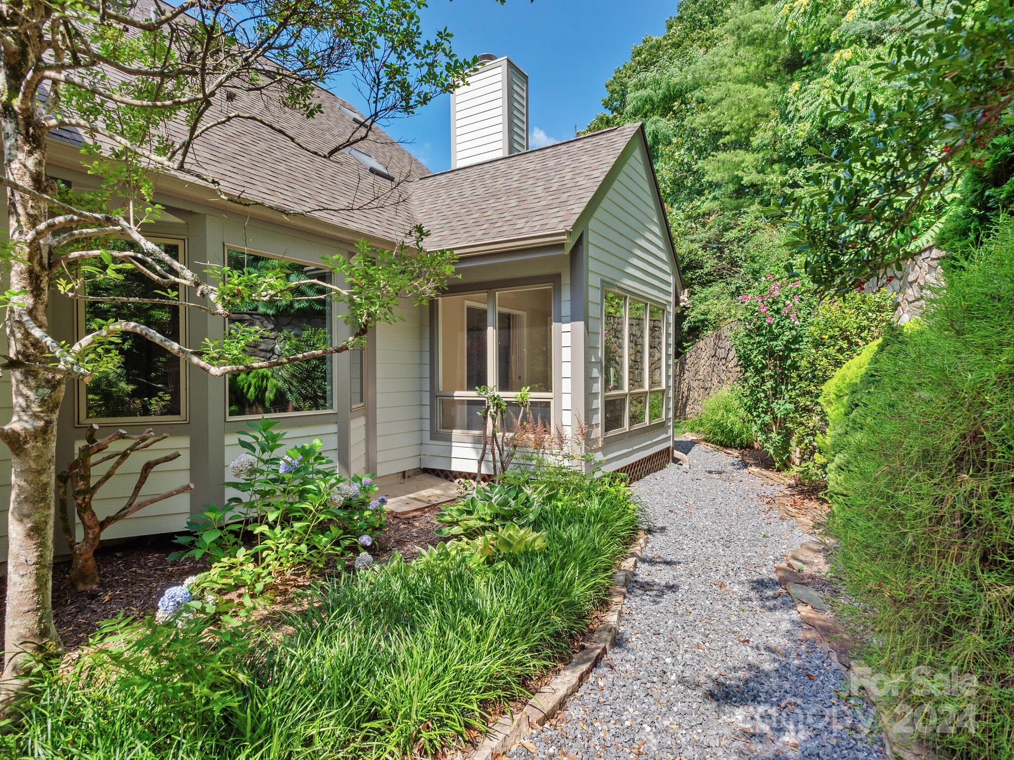 56 Pinnacle Point Drive Asheville, NC 28805 - Photo 5 of 38 front view of a house with a garden
