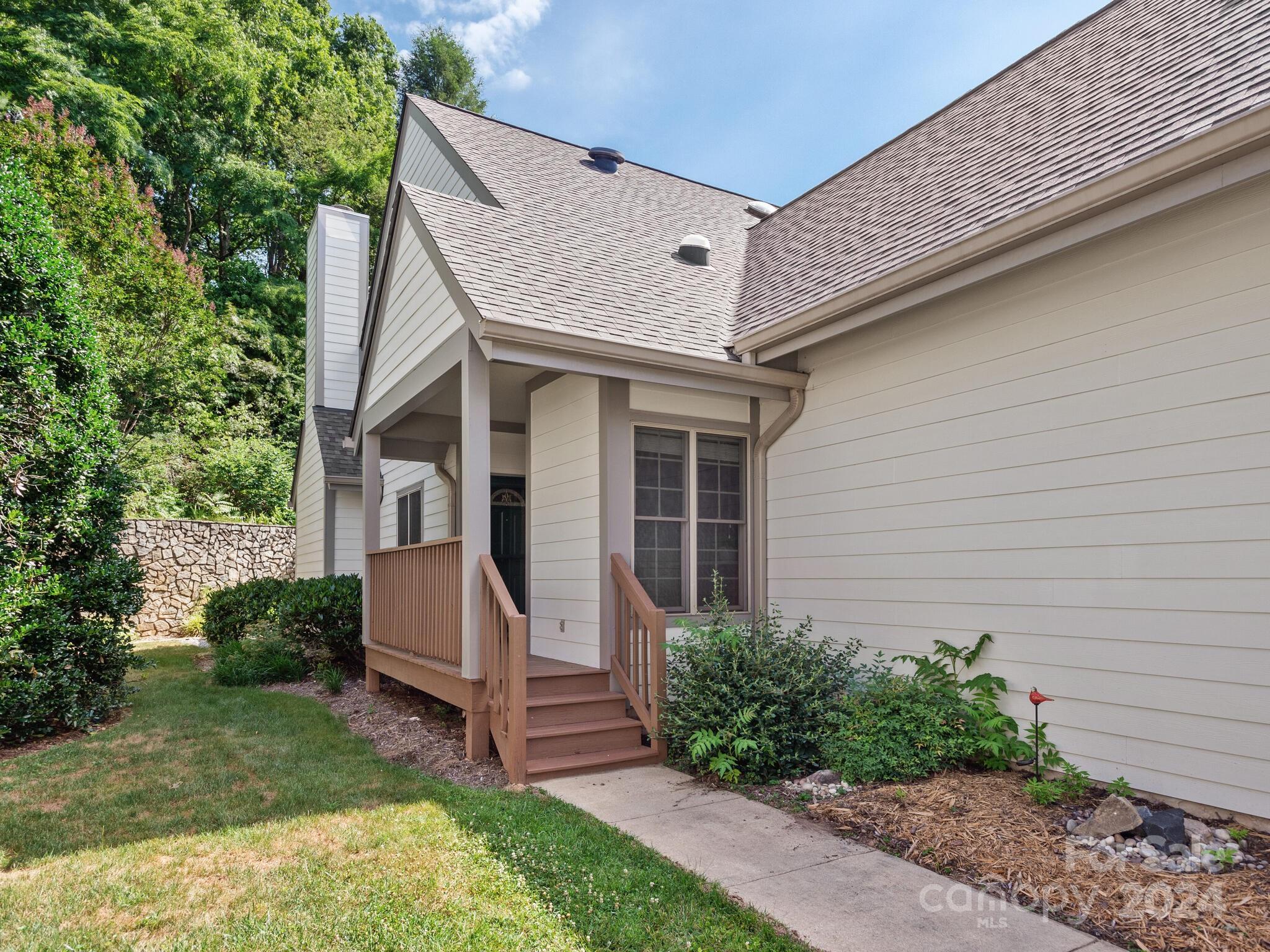 56 Pinnacle Point Drive Asheville, NC 28805 - Photo 7 of 38 a view of a white house next to a yard