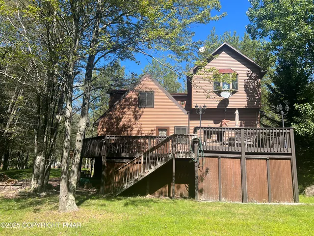 a kitchen with stainless steel appliances granite countertop a refrigerator a stove a sink dishwasher and white cabinets with wooden floor