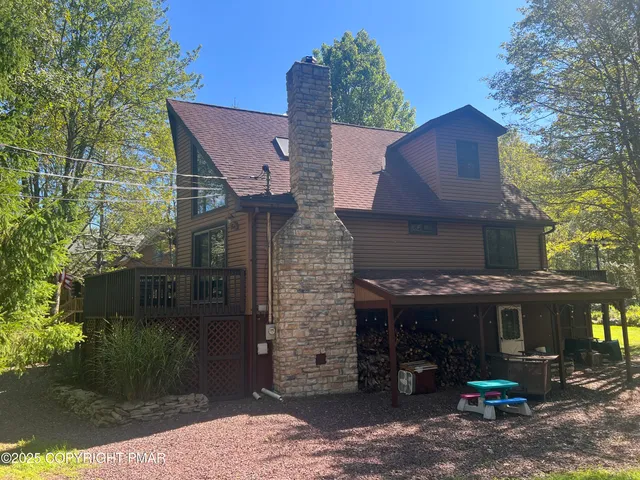 a kitchen with stainless steel appliances granite countertop a refrigerator a stove and a sink with wooden floors