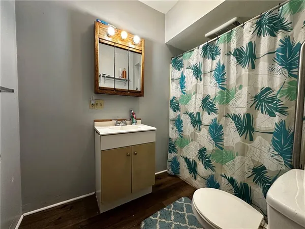a bathroom with a sink mirror vanity and toilet