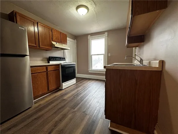 a kitchen with a cabinets and wooden floor