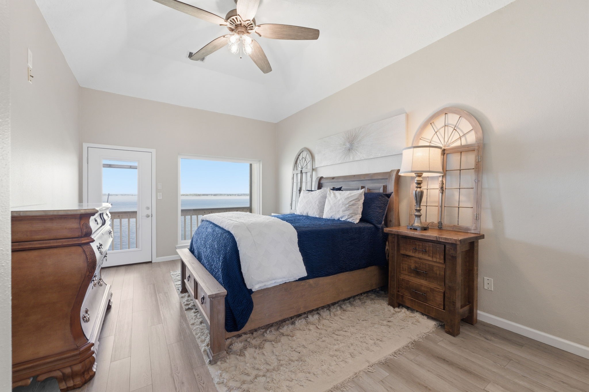 2 Regency Point Conroe, TX 77356 - Photo 15 of 44 Spacious primary bedroom with access to a screened-in balcony, perfect for enjoying morning coffee and taking in the beautiful open water views.
