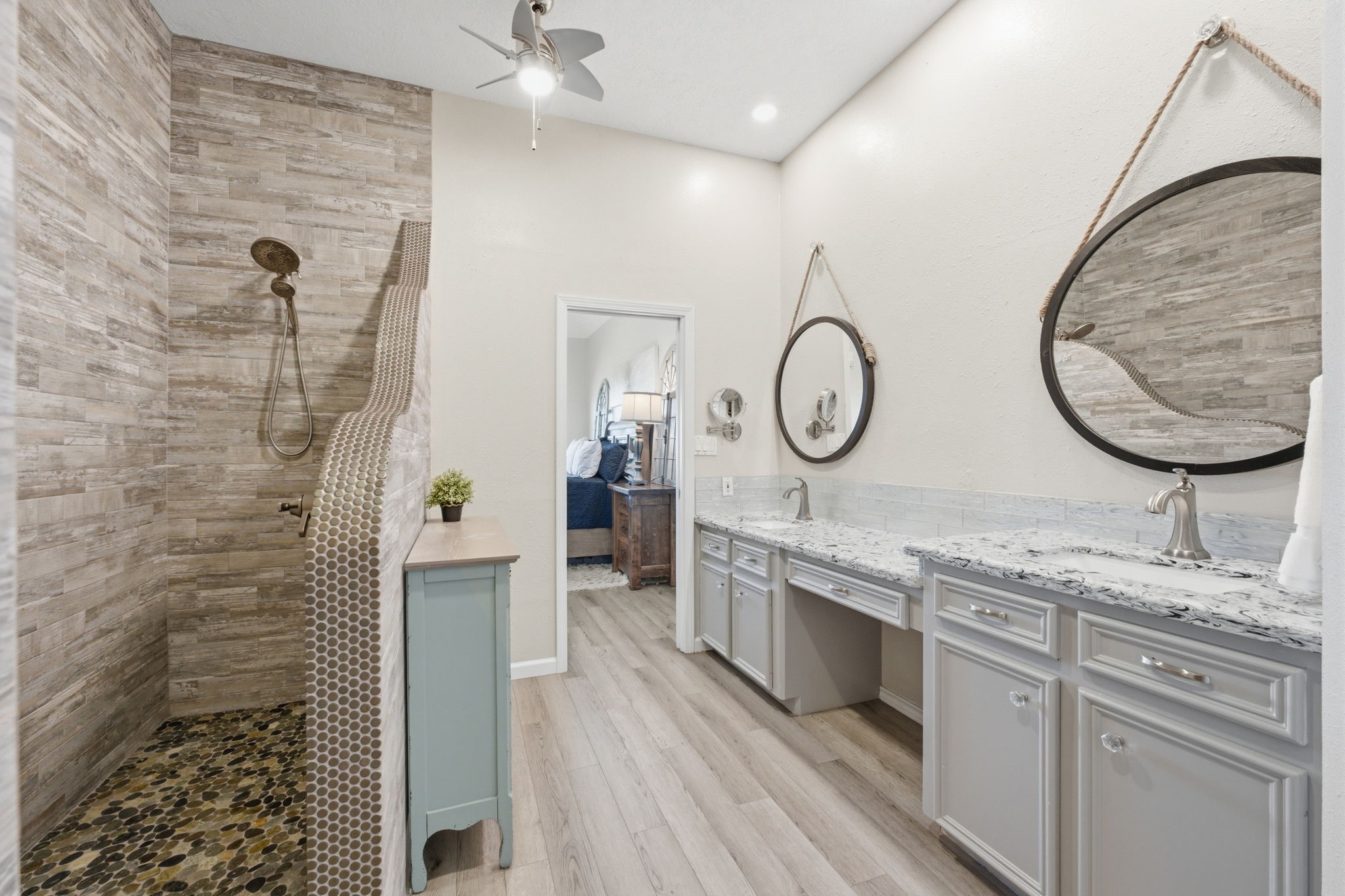 2 Regency Point Conroe, TX 77356 - Photo 18 of 44 Spa-inspired primary bathroom with dual vanities, Cambria quartz countertops, walk-in closet, and a beautifully designed walk-in shower with custom tile detail.