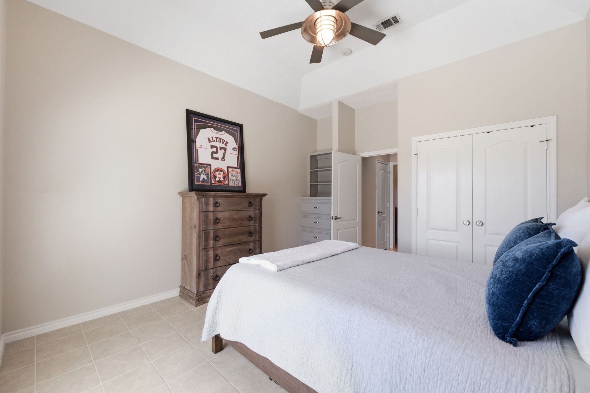 2 Regency Point Conroe, TX 77356 - Photo 23 of 44 Spacious secondary bedroom with high ceiling, built-in corner dresser, abundant natural light, and ample closet space.