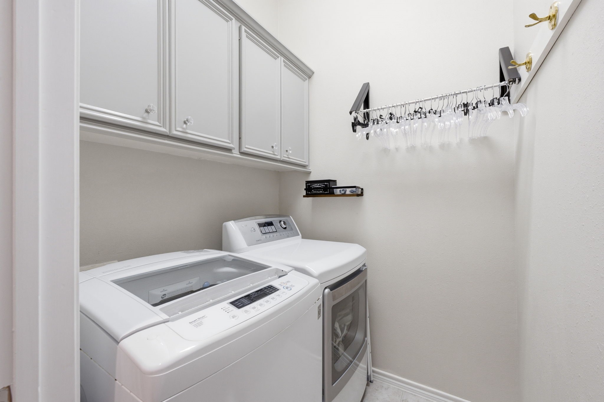 2 Regency Point Conroe, TX 77356 - Photo 25 of 44 Convenient upstairs laundry room with built-in cabinetry and hanging space - thoughtfully designed to enhance everyday living