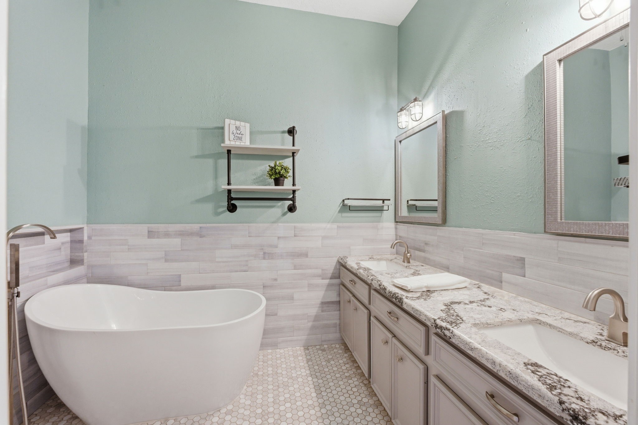 2 Regency Point Conroe, TX 77356 - Photo 26 of 44 Secondary bathroom with dual sinks, Cambria quartz countertops, and a freestanding soaking tub for a spa-like feel.