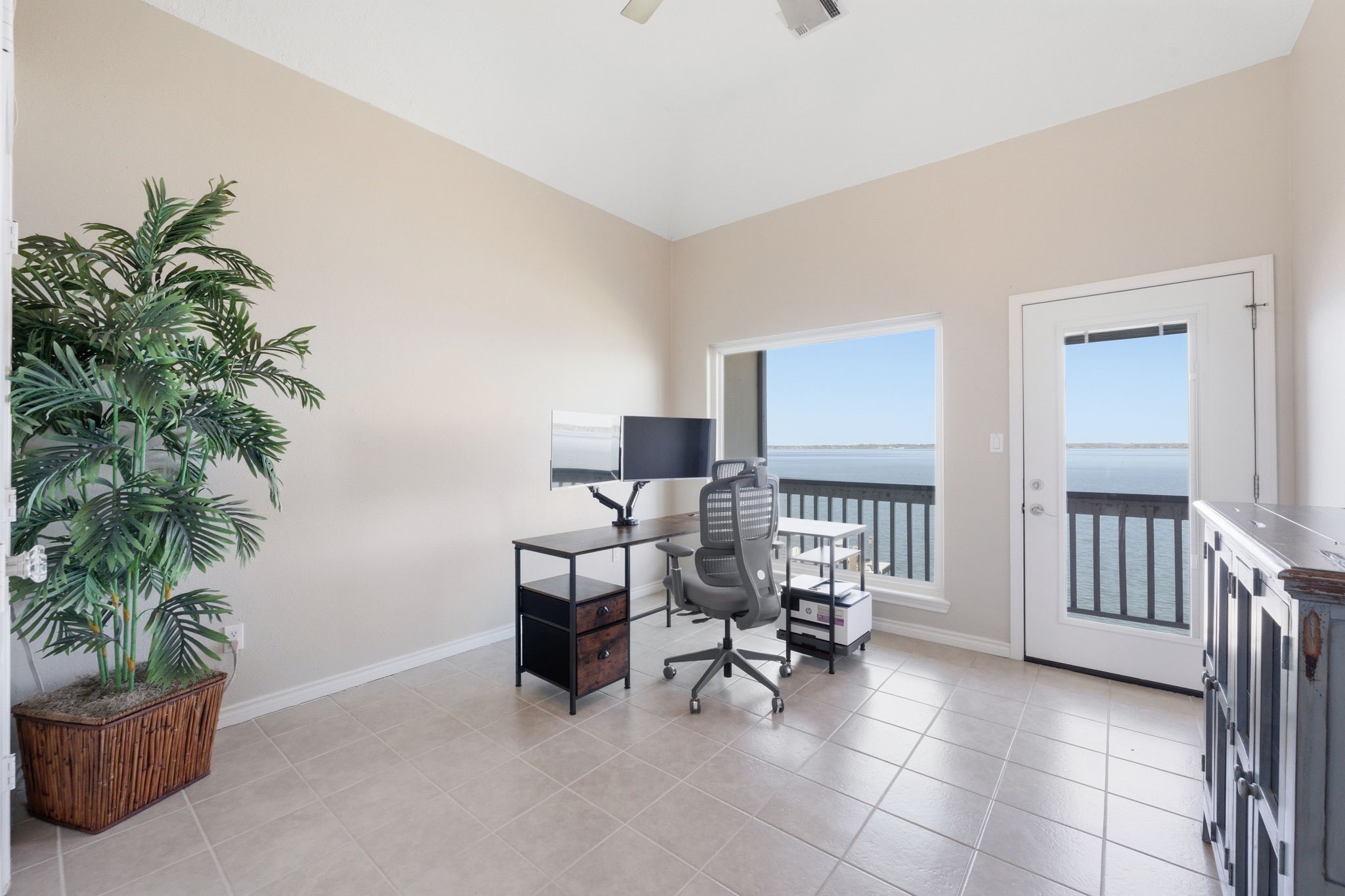 2 Regency Point Conroe, TX 77356 - Photo 27 of 44 Versatile secondary bedroom with high ceilings, currently being used as a home office, featuring balcony access with beautiful open water views.