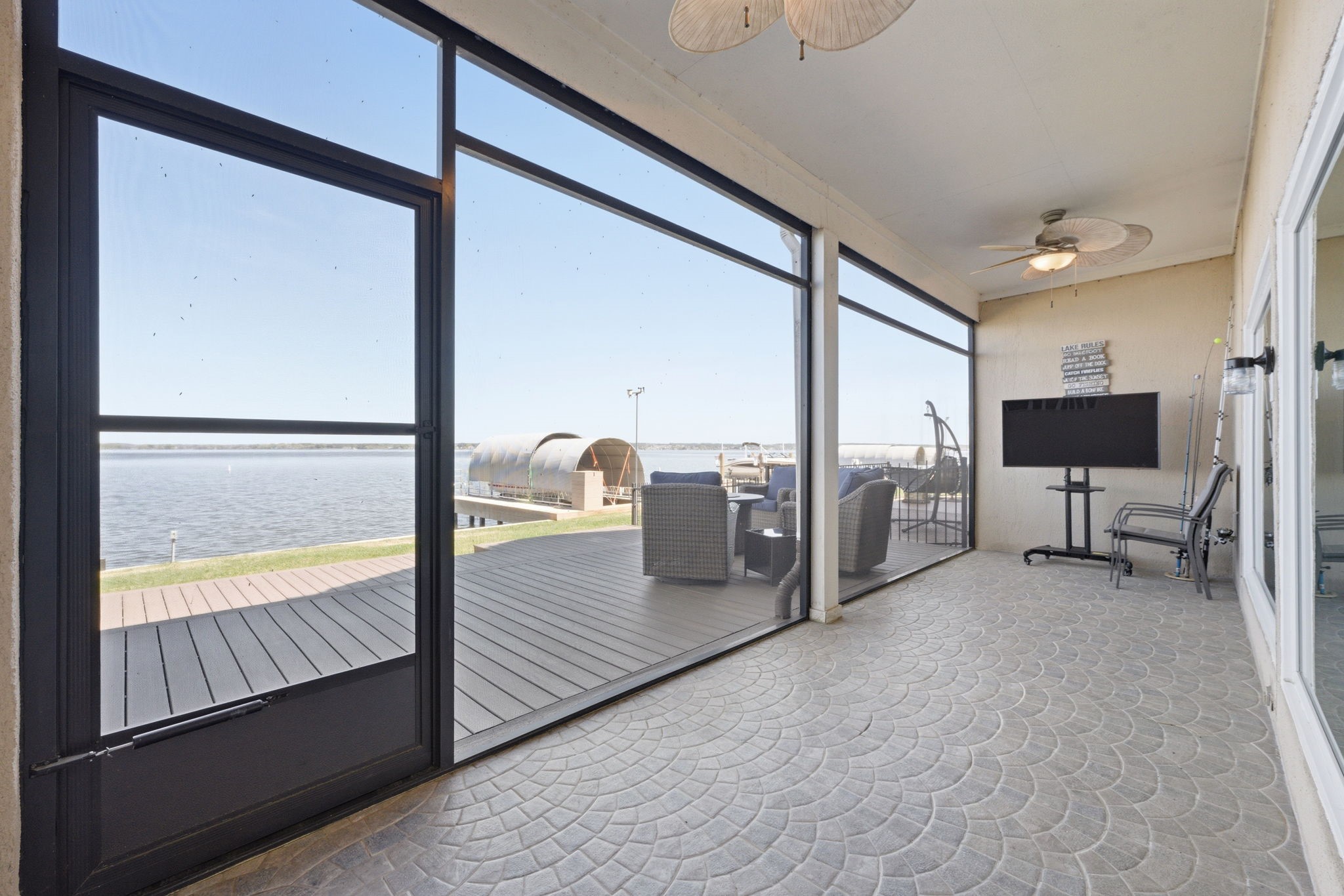 2 Regency Point Conroe, TX 77356 - Photo 30 of 44 Expansive screened-in porch offering the perfect space to relax, entertain, and enjoy breathtaking open water views year-round.
