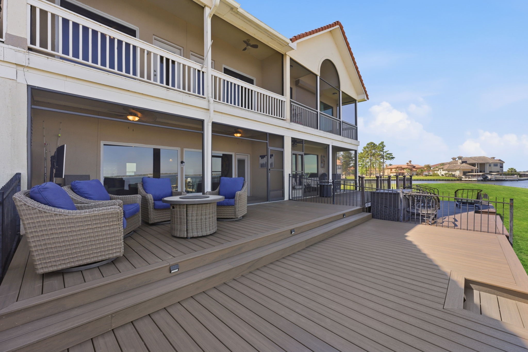 2 Regency Point Conroe, TX 77356 - Photo 31 of 44 Spacious multi-level deck designed for outdoor living, featuring ample seating areas and seamless access to the screened-in porch—all set against stunning open water views.