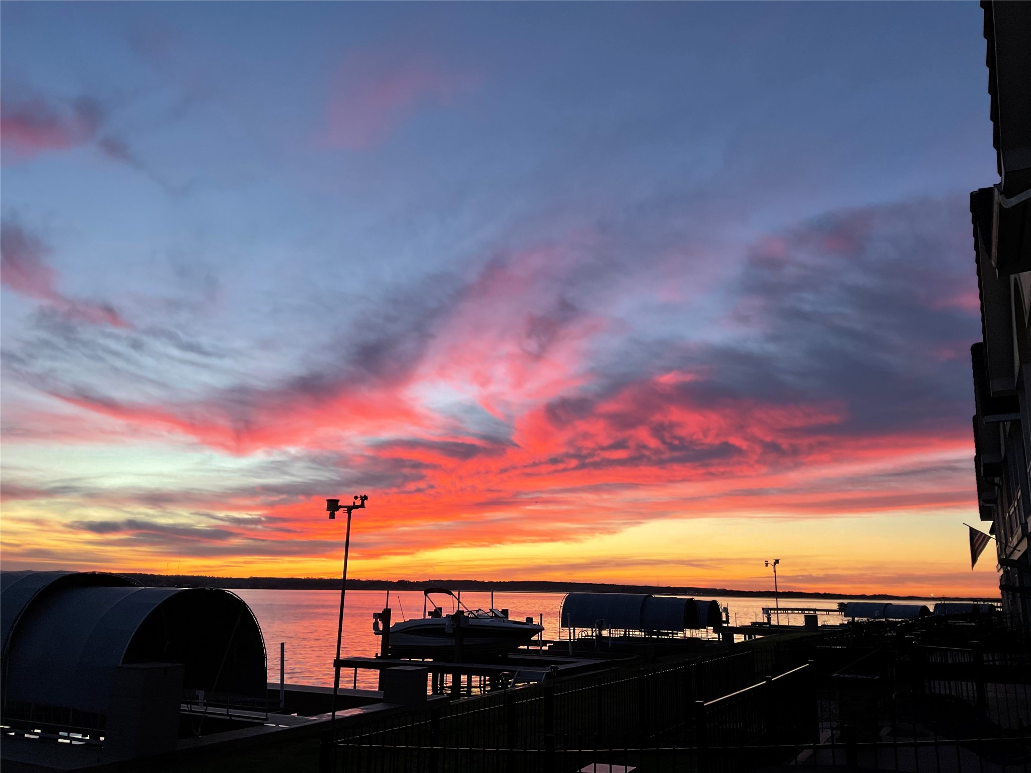 2 Regency Point Conroe, TX 77356 - Photo 43 of 44 Stunning sunrise views paint the sky with vibrant color, creating a peaceful and ever-changing waterfront backdrop to start your day.