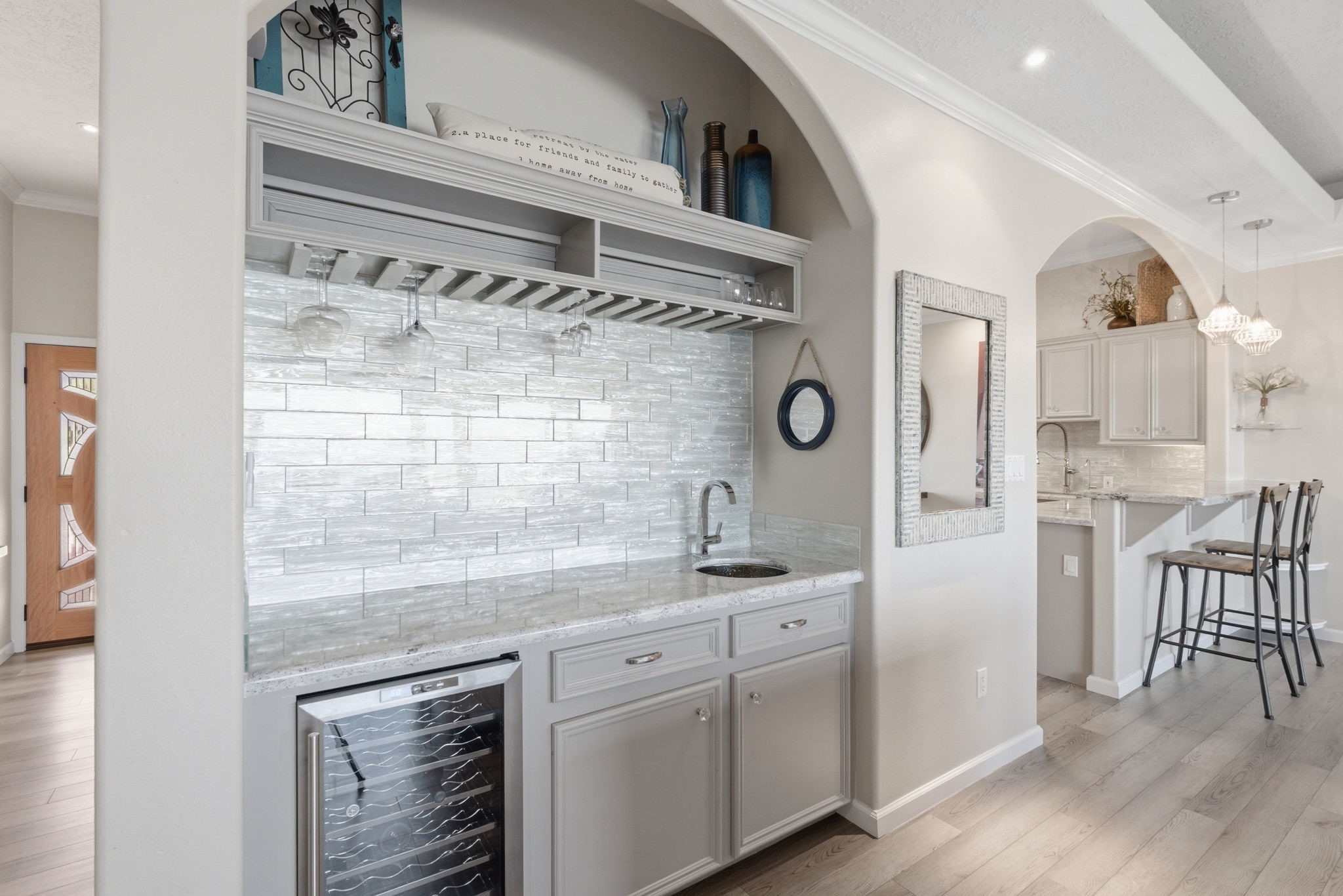 2 Regency Point Conroe, TX 77356 - Photo 10 of 44 Beautiful wet bar with wine fridge, sink, and custom cabinetry, perfectly positioned for entertaining just off the main living area.