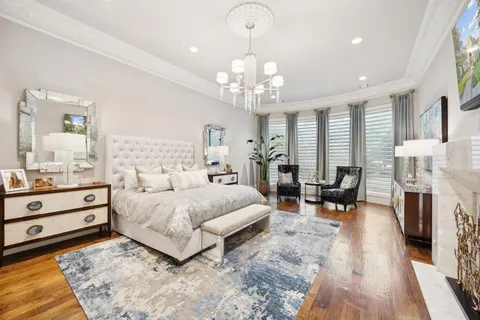 a spacious bedroom with a bed a couch and dresser