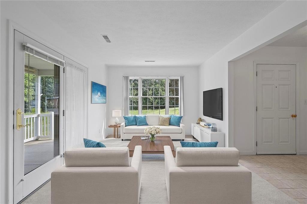 903 Hidden Meadows Circle Renfrew, PA 16053 - Photo 11 of 44 a living room with furniture a flat screen tv and a large window