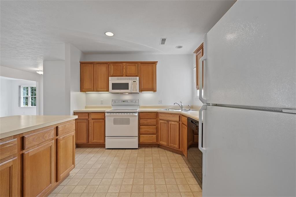 903 Hidden Meadows Circle Renfrew, PA 16053 - Photo 17 of 44 a kitchen with stainless steel appliances granite countertop a sink and a stove top oven