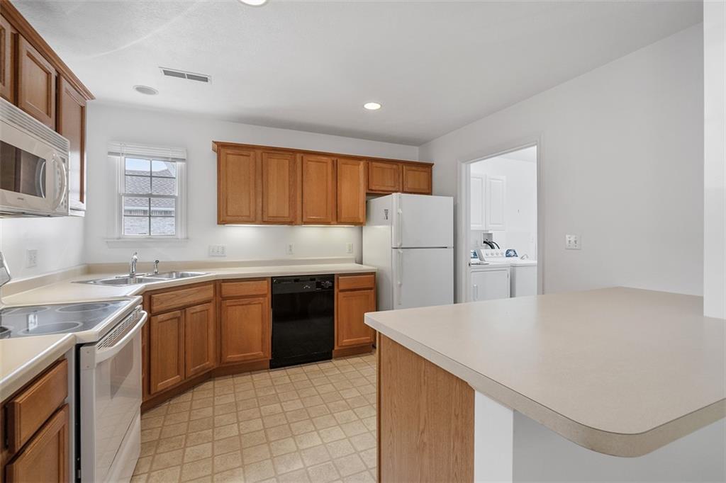 903 Hidden Meadows Circle Renfrew, PA 16053 - Photo 20 of 44 a kitchen with a refrigerator a sink dishwasher and wooden cabinets
