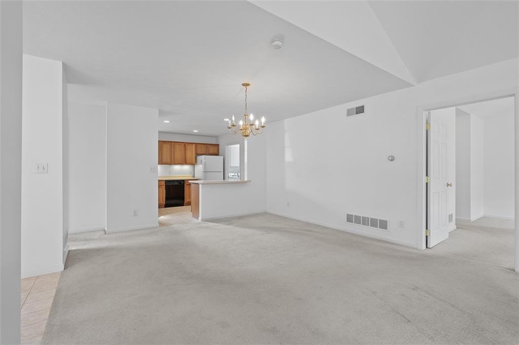 903 Hidden Meadows Circle Renfrew, PA 16053 - Photo 24 of 44 an empty room with chandelier and windows