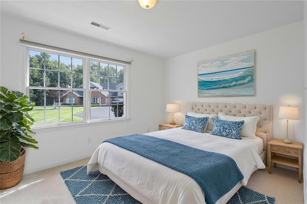 903 Hidden Meadows Circle Renfrew, PA 16053 - Photo 33 of 44 a bedroom with a large bed and a potted plant