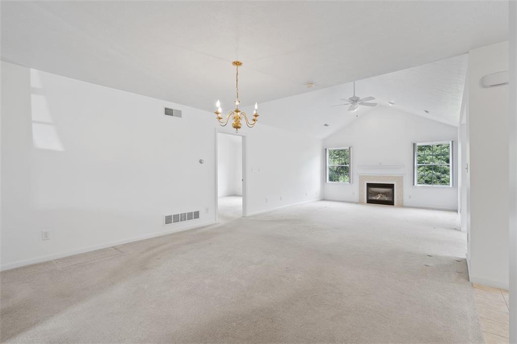 903 Hidden Meadows Circle Renfrew, PA 16053 - Photo 6 of 44 en empty room with windows and fireplace