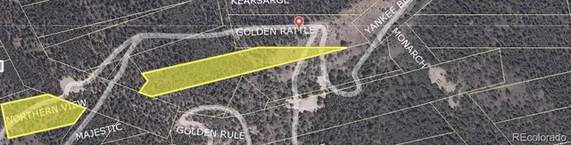 a view of a yard with wooden fence