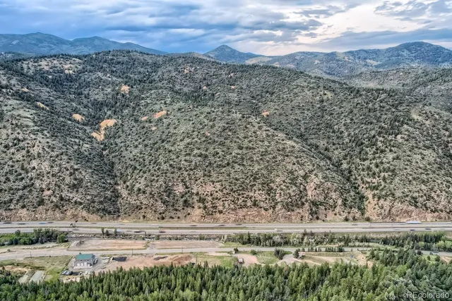 a view of a yard with wooden fence