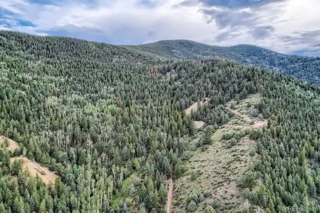 a view of a field with mountains in the background