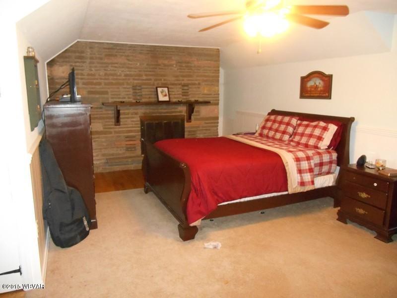 10001 State Rte 414 Roaring Branch, PA 17765 - Photo 3 of 15 Bedroom with fireplace