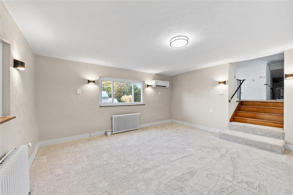 1812 Ridge Road Jeannette, PA 15644 - Photo 13 of 39 a view of an empty room with wooden floor and a window