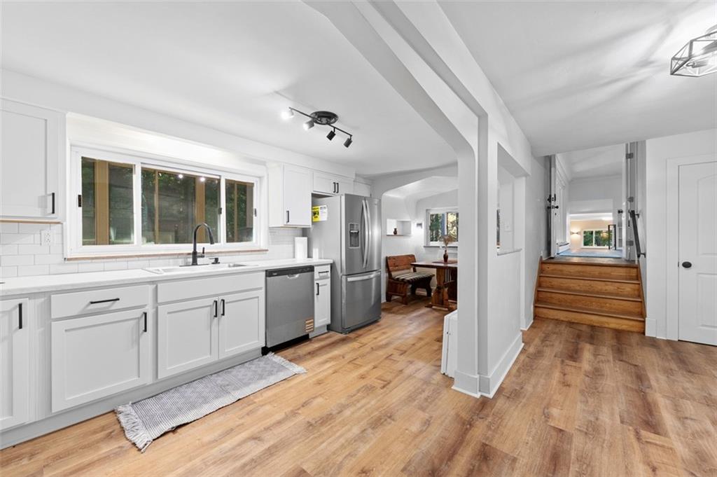 1812 Ridge Road Jeannette, PA 15644 - Photo 14 of 39 a large white kitchen with a sink and dishwasher a refrigerator