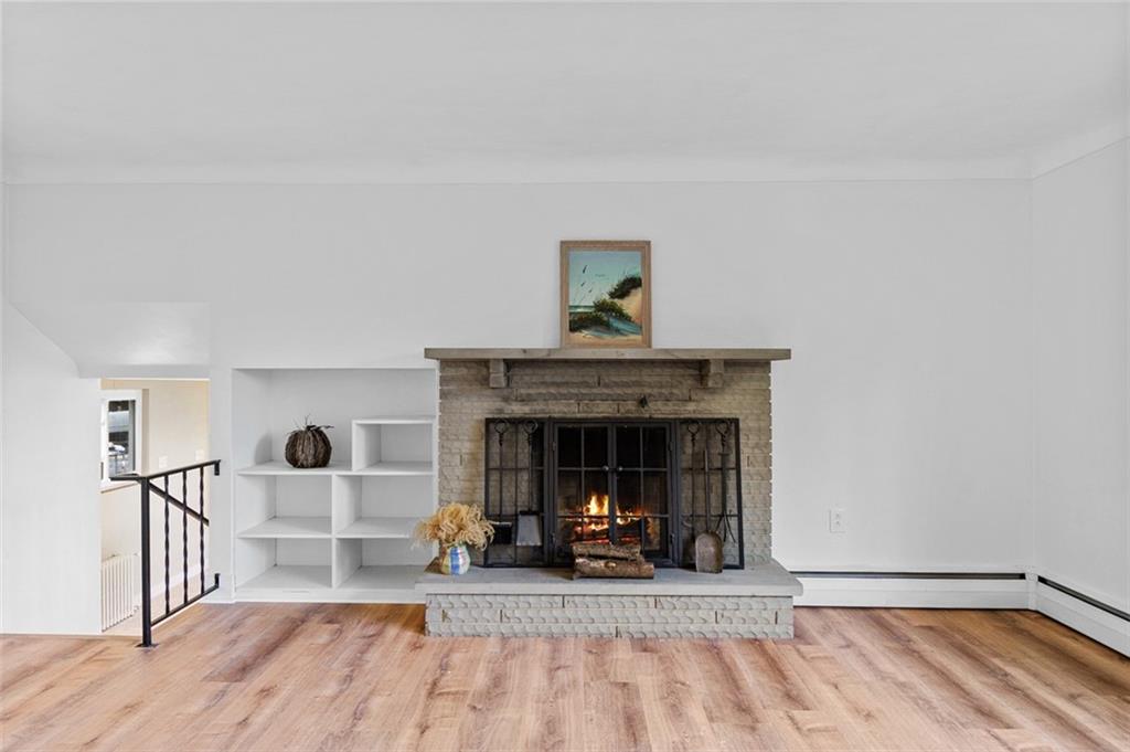 1812 Ridge Road Jeannette, PA 15644 - Photo 10 of 39 a view of a livingroom with a fireplace and wooden floor