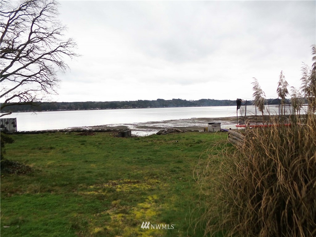 4227 Northeast North Shore Road Belfair, WA 98528 - Photo 1 of 14 a view of a lake with a big yard