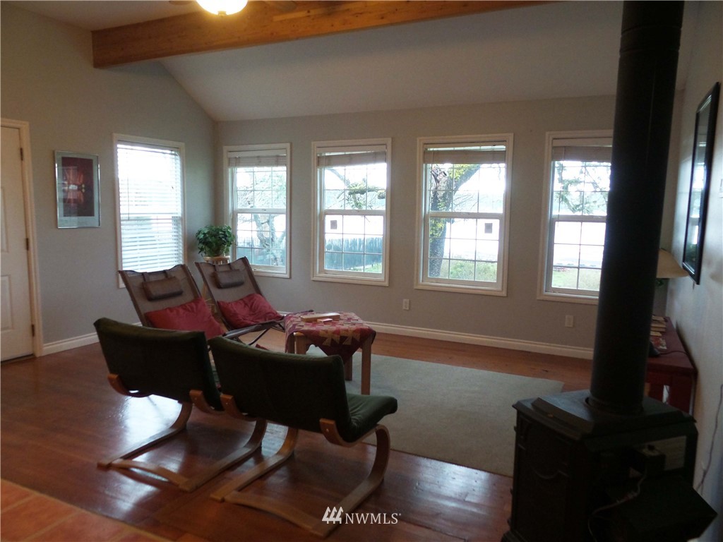 4227 Northeast North Shore Road Belfair, WA 98528 - Photo 4 of 14 a living room with furniture and a floor to ceiling window