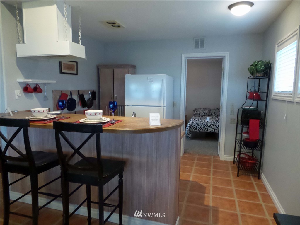 4227 Northeast North Shore Road Belfair, WA 98528 - Photo 6 of 14 a kitchen view of a dining table chairs and entryway