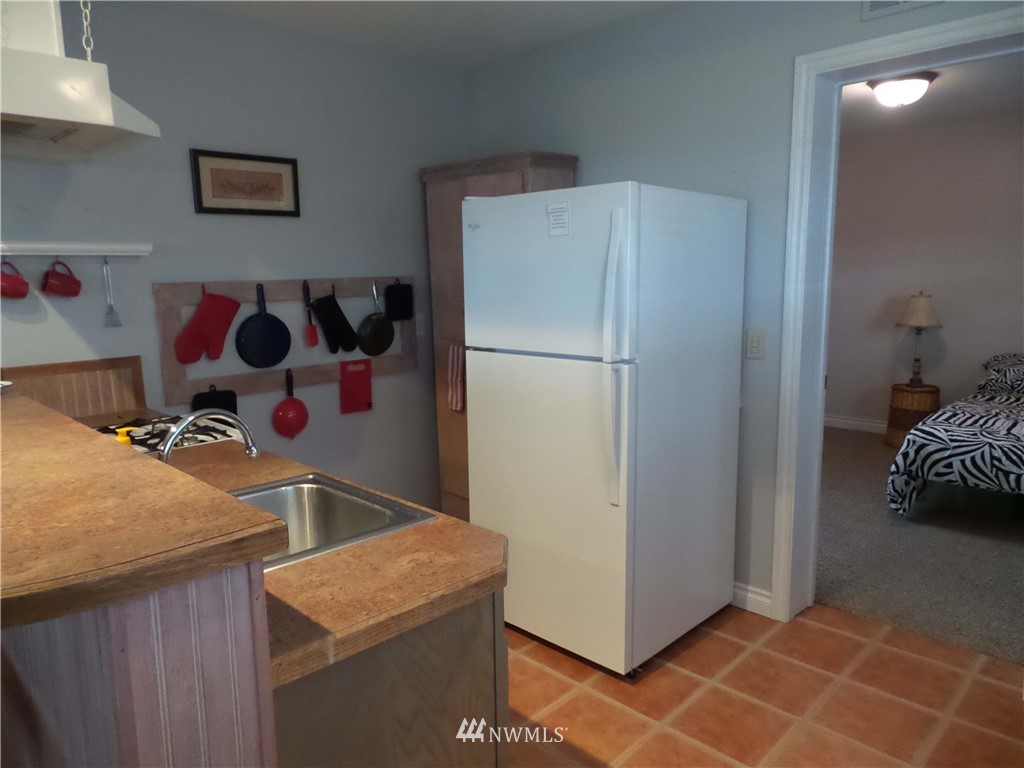 4227 Northeast North Shore Road Belfair, WA 98528 - Photo 7 of 14 a kitchen with a refrigerator and a sink