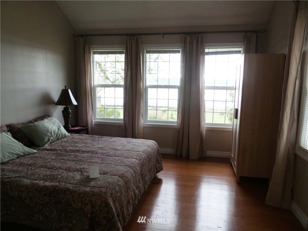 4227 Northeast North Shore Road Belfair, WA 98528 - Photo 8 of 14 a bedroom with a bed and a window