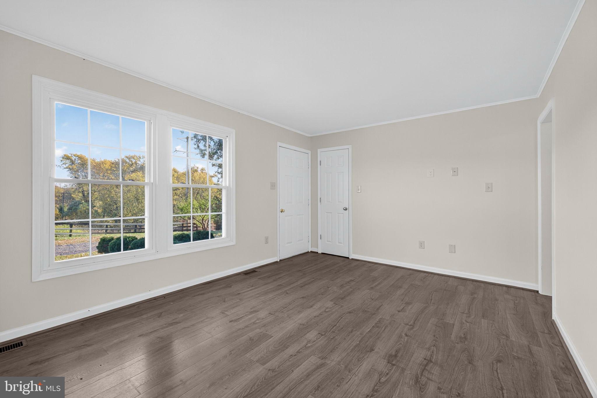 33018 Sunken Lane Upperville, VA 20184 - Photo 5 of 31 an empty room with wooden floor and windows