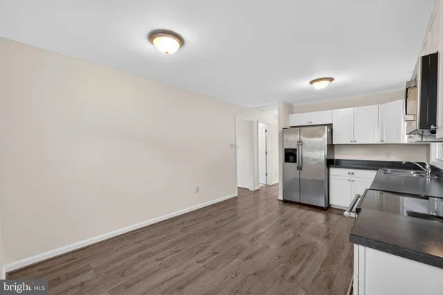 a view of a kitchen with a sink and a refrigerator