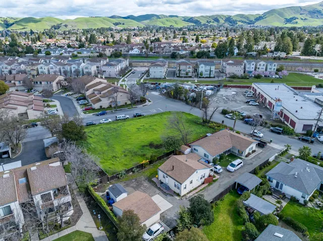 an aerial view of a house with a garden and yard
