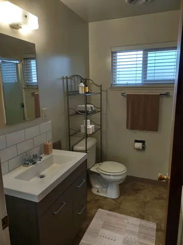 a bathroom with a sink toilet and mirror
