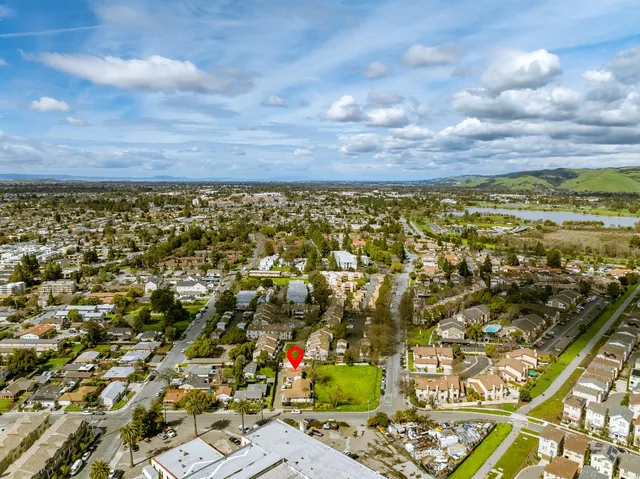 a kitchen with cabinets appliances a sink and a window