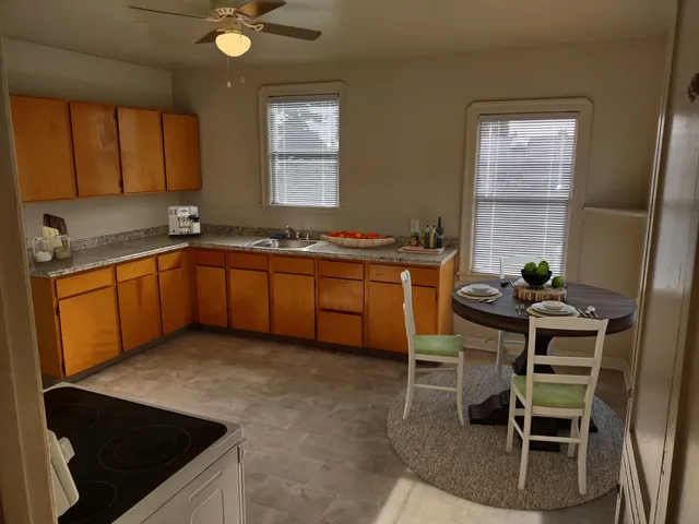 a kitchen with stainless steel appliances granite countertop sink stove and cabinets